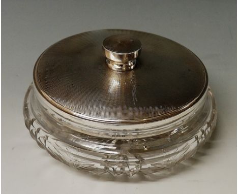 A silver topped dressing table jar, the glass body cut with flowers, the lid engine turned, indistinct maker's mark, London 1