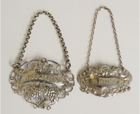 Two silver decanter labels, the first an early Victorian example, pierced, chased and embossed with bunches of grapes and tra