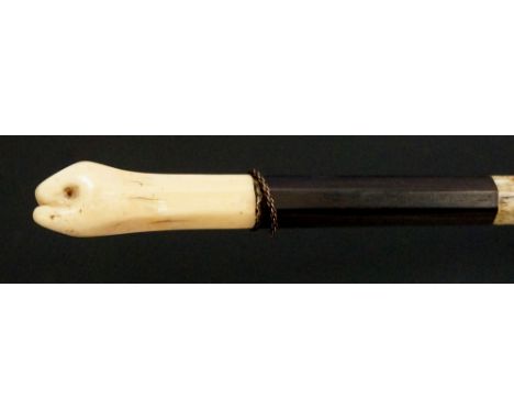 A good 19th Century walking stick, the marine ivory handle carved as an upright clenched fist, thin chain link collar above t