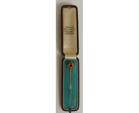 A gold knot stick pin, 7cm high in original fitted box inscribed  John Hall & Co, Diamond Merchants, 56 King Street, Manchest