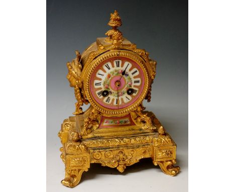 A late 19th Century gilt metal and porcelain mantel clock in the French taste, the drum shaped case with rose pompadour dial 