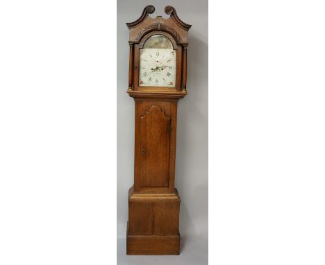 An early George III oak longcase clock the swan neck pediment with floral carved terminals, fret carved arch above an arched 