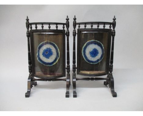 A pair of Victorian black painted, bow front table screens, fashioned as fire screens, with a spindle gallery and a slice of 