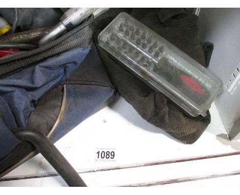 A toolbag with wheel braces and many tools etc