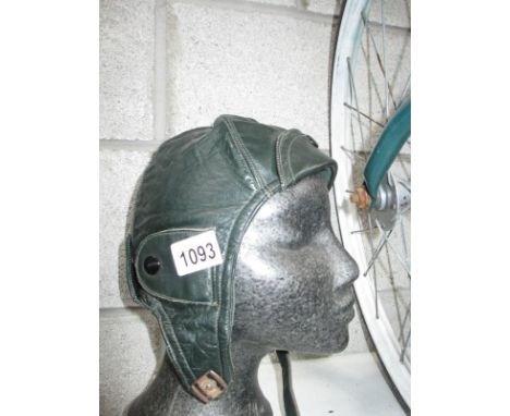 A vintage green leather motorcycle helmet size 60