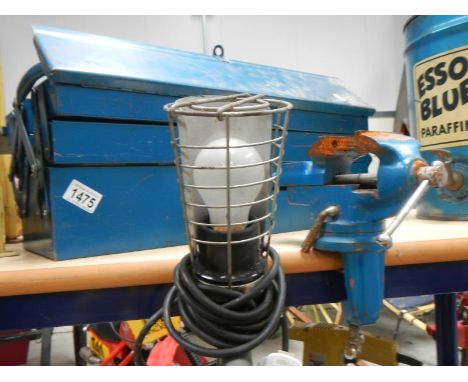 A good cantilever metal tool box with contents, a clamp vice and a work light.