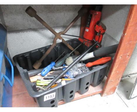A box of miscellaneous tools including bottle jack