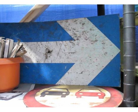 An old one way arrow road sign and a reproduction No Overtaking Road sign