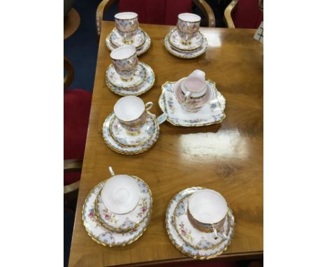 TUSCAN TEA SERVICE, with floral and gilt decoration on a pink ground, comprising 12 trios, sugar, cream and cake plate