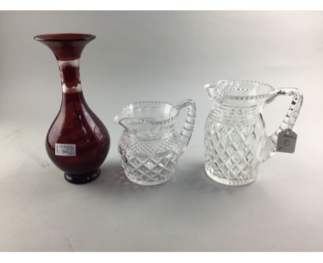 RUBY GLASS VASE, with bird motif, 27cm high, along with two crystal jugs (3)