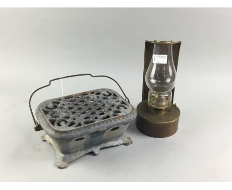 CAST IRON CARRIAGE FOOTWARMER, along with an oil lamp (2)