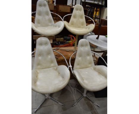 A vintage set of four 1970's atomic space age styled dining chairs on chrome frames with white button back vinyl seats and ma