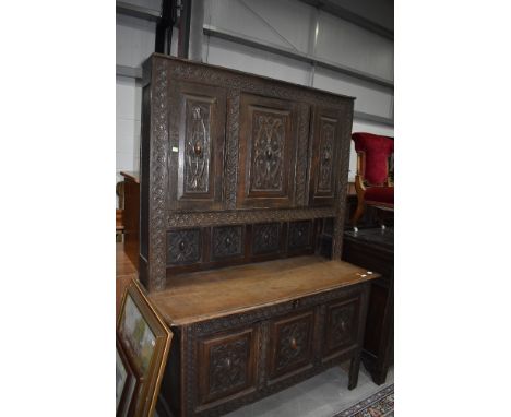 A late 19th century converted oak Kist base having similar dresser back with carved panel doors, approx W133cm overall height