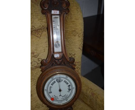 An early 20th Century oak cased aneroid barometer with thermometer to stem