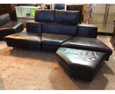 A Rolf Benz sectional sofa with three angular sections, two attachable headrests and footstool, all in black leather (67cm x 