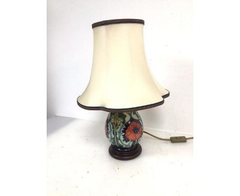A Moorcroft table lamp of baluster form with poppy pattern on circular base, complete with shade (44cm)