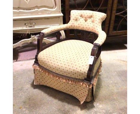 A Victorian stained pine armchair with later upholstery, with repeating stylised flowerhead design, with button back with pie