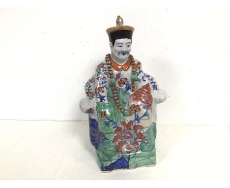 An early 20thc Chinese ceramic sculpture of a Seated Noble, with foliate decoration, and a blue seal mark to base (34cm x 21c