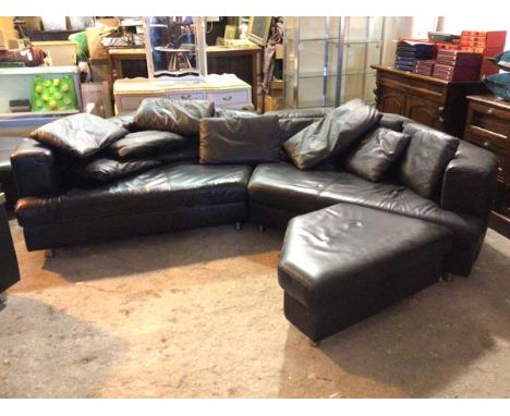 A Rolf Benz sofa, comprised of two angular sections, a collection of cushions and footstool, all in black leather (with Rolf 