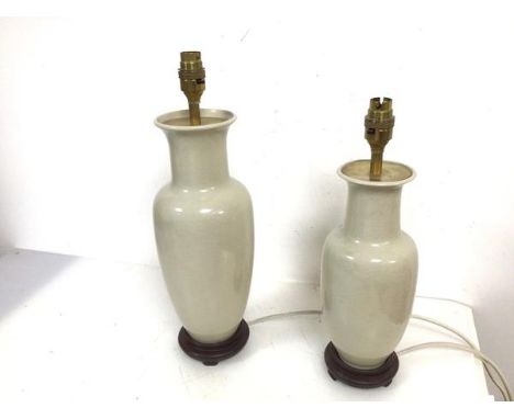 A crackle glazed baluster form table lamp on wooden stand and similar smaller lamp (larger: 42cm to top of lamp holder)