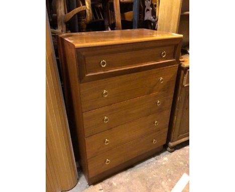 A mid century style teak chest of drawers, the top drawer with panelled front above four long drawers, all with gilt metal dr