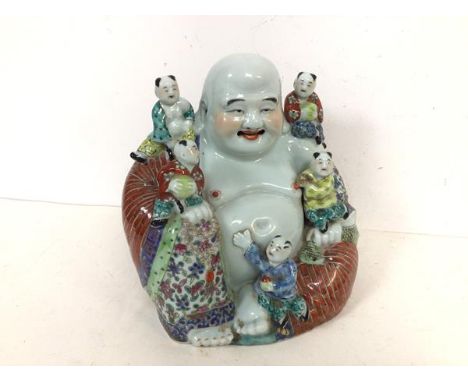 A handsome Chinese ceramic Seated Buddha with five children, all with elaborate polychrome decorated garments, Buddha holding