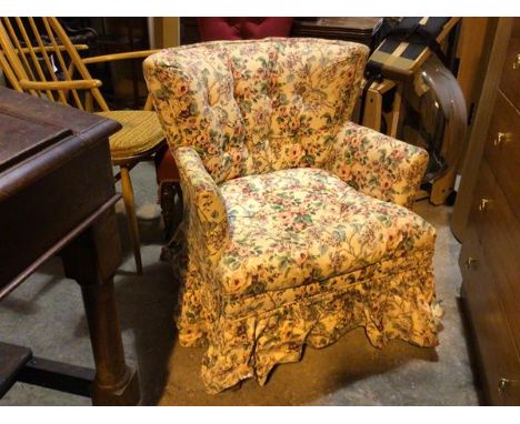 A low armchair in floral upholstery with button back (85cm x 67cm x 67cm)