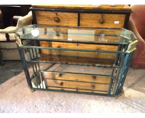 A contemporary console table with verdigris and metal frame, with bevelled glass top above a glass middle tier and mirrored b