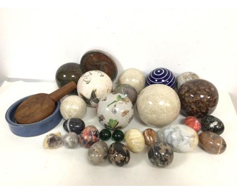 A mixed lot including a collection of glass, ceramic and stone boules, and a similar collection of eggs along with a coaster,