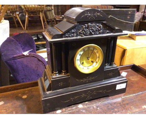 An Edwardian slate mantle clock of typical architectural form, with pediment depiciting cherubs (38cm x 38cm x 14cm)