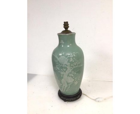 A table lamp of baluster form, with prunus decoration, on pierced wooden base (48cm to top of lamp holder)