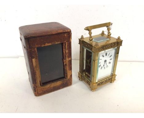 A late 19thc/early 20thc four glass carriage clock, with foliate frieze supported by pilasters, on foliate base, complete wit