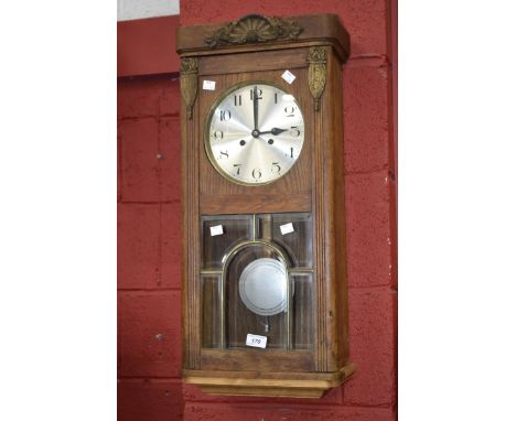 An oak rectangular wall clock, circular silvered dial, Arabic numerals, c.1935