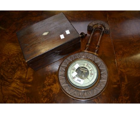 A Victorian carved mahogany aneroid wheel barometer; a Victorian rosewood work box (2)