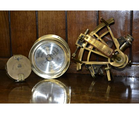 A reproduction brass sextant; a Howard Miller aneroid brass cased barometer; a reproduction compass (3)