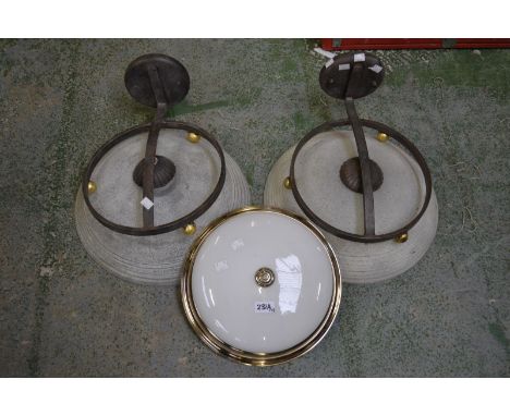 Two wrought iron wall lights; a contemporary domed ceiling light (3)