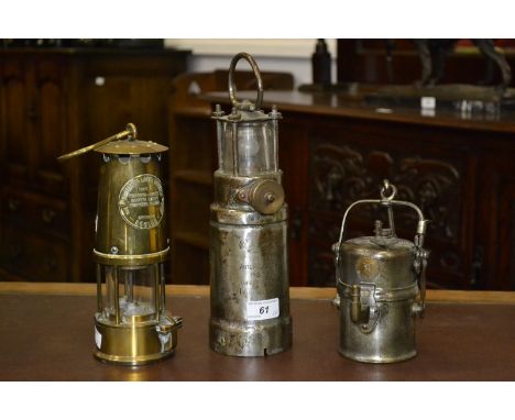 An Eccles Projector Lamp and Lighting Co. Ltd type 5 miners lamp; Premier carbide lamp.; an Oldham Automatic 110 volt battery