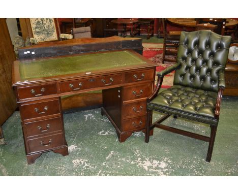 A reproduction mahogany pedestal desk, inlaid leather top, an arrangement of nine drawers; a leather button upholstered chair