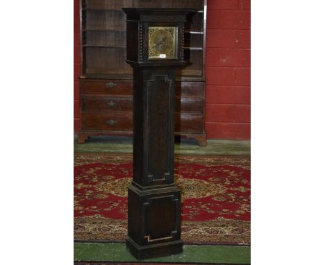 An oak grandmother clock, stepped cornice, blind fretworked frieze, brass chapter ring, Roman numerals, floral spandrels, fla