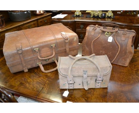 A Vintage leather suitcase; a vintage leather holdall; a small leather military case (3)