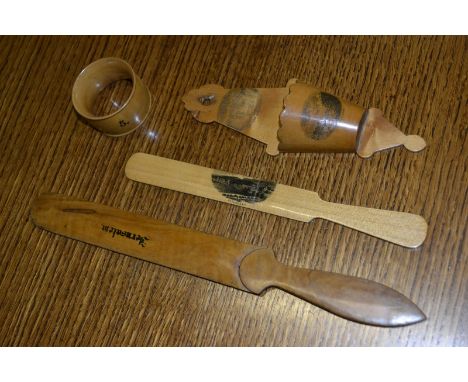 Two mauchline ware treen page turners; a wall pocket; a napkin ring (4)