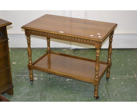 A Priory style light oak tea trolley, moulded rectangular top, undertier, turned supports, casters.