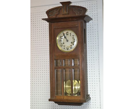 An Art Nouveau carved oak chiming wall clock, silvered dial, Arabic numerals