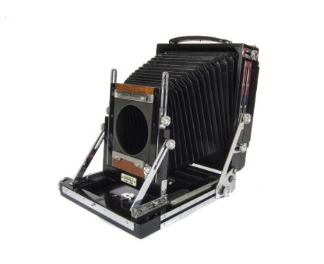 A Gandolfi Half Plate Mahogany Camera, black and chrome, serial no. 33, body, VG, lacking lock arm, with spare ground glass b