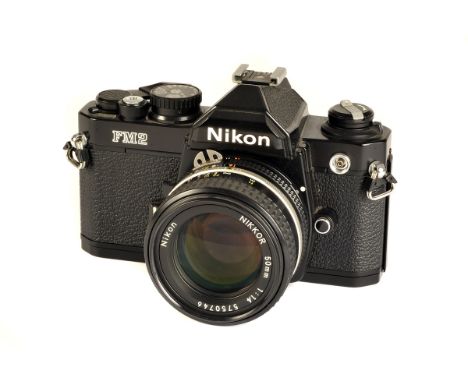 A Nikon FM2n SLR Camera, black, serial no. 7751110, with AIS f/1.4 50mm lens, black, serial no. 5750746, body, VG, shutter wo