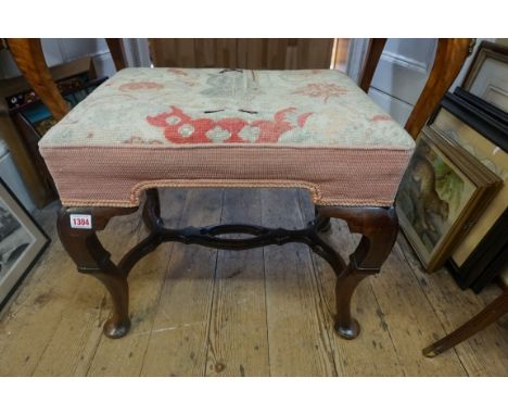A Queen Anne walnut and upholstered stool, the tapestry seat decorated with a 17th century figure, 55cm wide.&nbsp; 