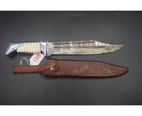 A German Bowie style knife and leather sheath, having a 20cm blade inscribed 'ERN, Wald-Solingen', with simulated ivory grip.