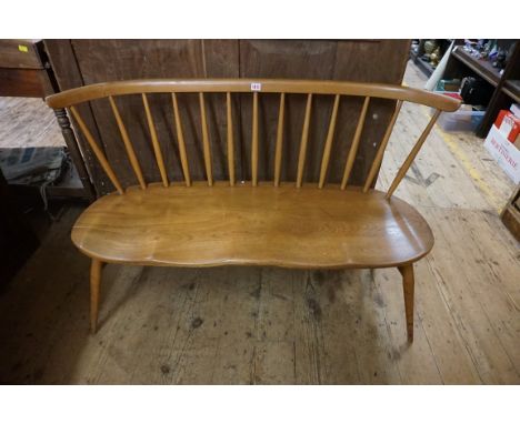 A vintage Ercol loveseat,&nbsp;121cm wide, (minor separation to ends of plank joints on seat). 