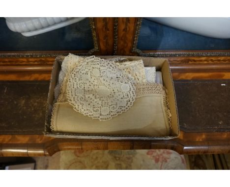 A small collection of lace doilies; and a linen tablecloth.&nbsp; 