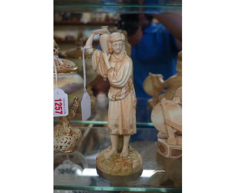 A Victorian Royal Worcester blush ivory figure of a water carrier, circa 1891, 20.5cm high. 